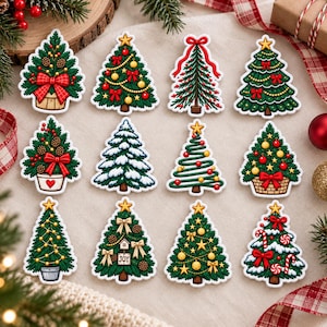 May include: A collection of twelve distinct Christmas tree ornaments featuring various designs, including trees with red bows, gold stars, pinecones, candy canes, and snow-dusted branches, all arranged in a grid on a neutral fabric surface.