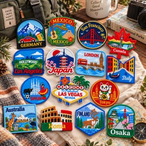 May include: A collection of colorful embroidered travel patches featuring iconic landmarks and symbols from various global destinations including Germany, Mexico, San Francisco, Canada, Los Angeles, Japan, London, Italy, Spain, Las Vegas, Tokyo, Australia, Roma, Finland, and Osaka.