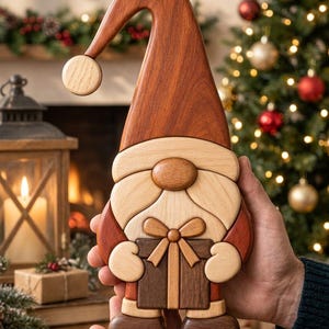 May include: A handcrafted wooden gnome figurine featuring a tall, curved reddish-brown hat with a light wood pom-pom, a light wood beard, and a dark wood gift box held in its hands. The gnome is constructed from various shades of natural wood.
