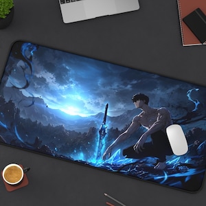 Könnte beinhalten: Eine rechteckige Schreibtischunterlage mit einer düsteren Fantasy-Illustration eines oberkörperfreien Charakters, der in einer nächtlichen Berglandschaft kniet. Die Szene zeigt ein leuchtendes blaues Schwert, wirbelnde Energieeffekte und helles Licht.