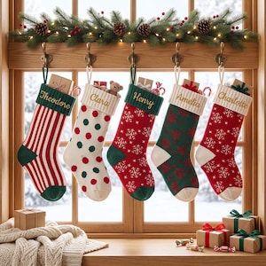 May include: Five personalised Christmas stockings hanging from hooks. The stockings feature names Theodore, Clara, Henry, Amelia, and Charlotte embroidered on ribbed cuffs. Patterns include red and white stripes, polka dots, and snowflakes in red and green.