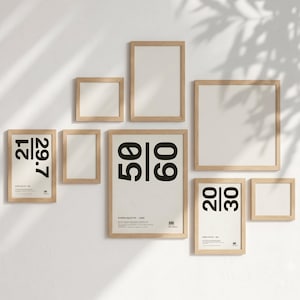 May include: A gallery wall set of eight light wood frames in various sizes. Three frames contain white posters with black text reading 21/29.7, 50/60, and 20/30. The remaining five frames are empty, featuring white matting. The frames are arranged in a cluster.
