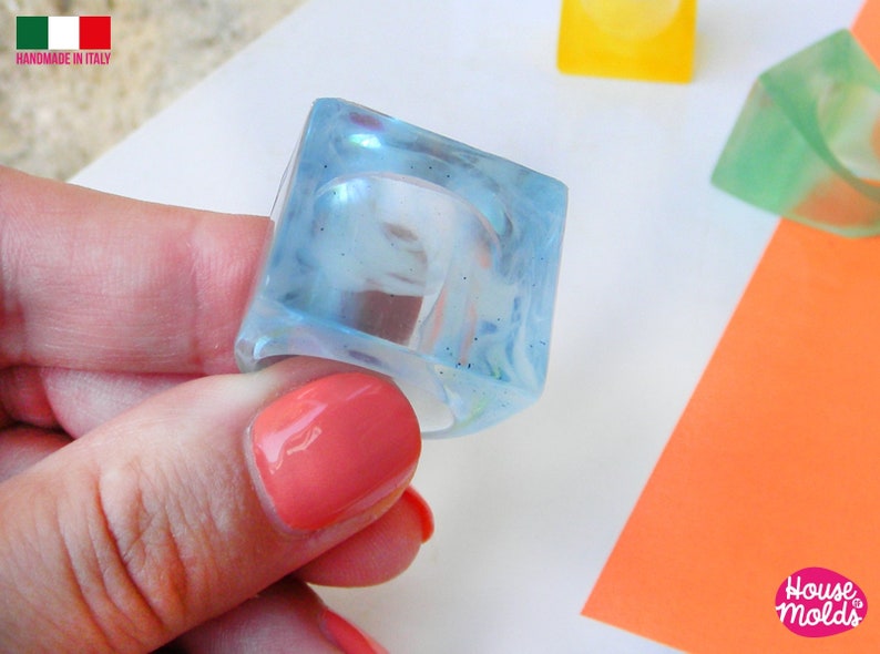 May include: A light blue square ring made of resin. The ring is handmade in Italy.