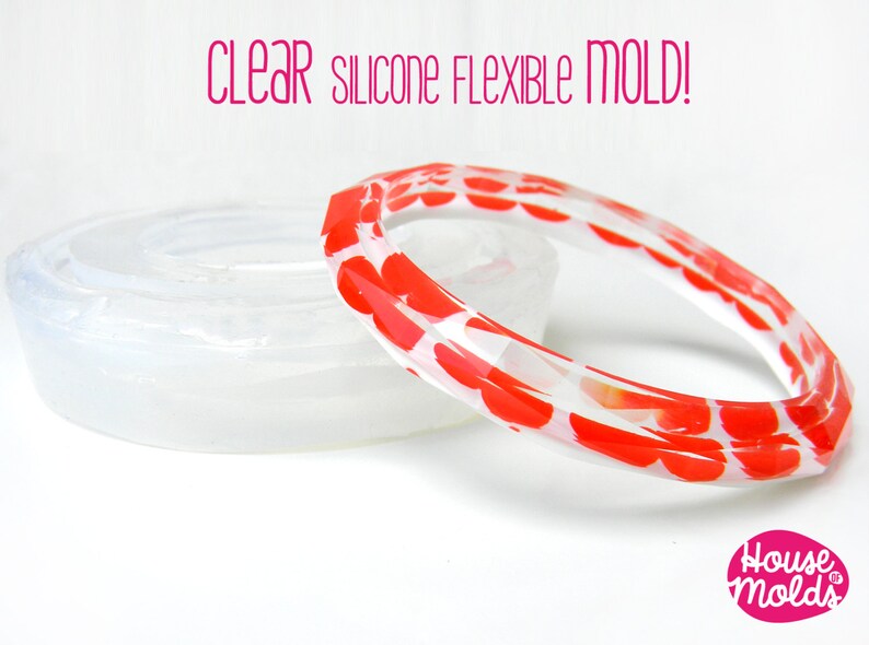 May include: Clear silicone flexible mould for making bracelets. The mould is shown with a red and white heart patterned bracelet made with the mould.
