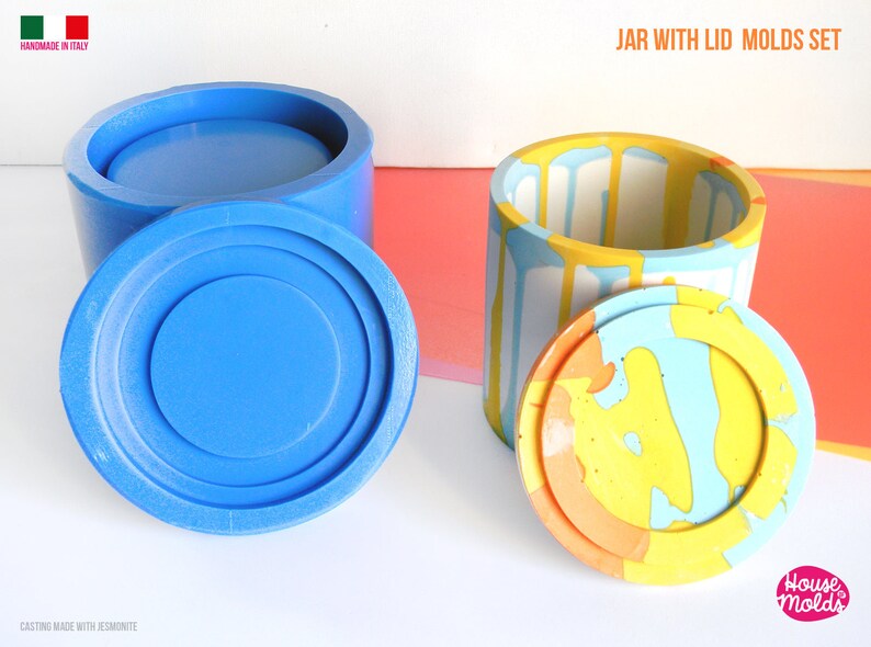May include: Two silicone moulds for making a jar with a lid. The moulds are blue and show the finished product in a colourful abstract design. The text "JAR WITH LID MOLDS SET" is at the top of the image. The text "House Molds" is at the bottom of the image.