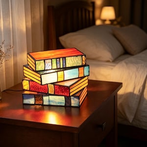 This stacked book-shaped stained glass table lamp is a book-themed night light, decorative item, and perfect for book lovers.
