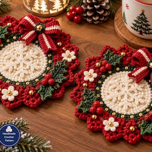 May include: Two round crochet coasters featuring a central cream-colored snowflake design surrounded by a red and green wreath border. Each coaster is decorated with a red and white striped bow, small white flowers, green holly leaves, red berries, and gold beads.