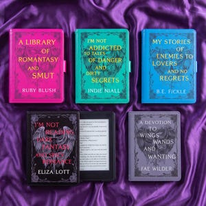May include: Five e-reader cases featuring ornate wing and sword illustrations with gold text. The cases are pink, teal, blue, black, and gray. The black case is open, displaying a screen with text. Each case has a decorative border.