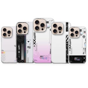 May include: Five smartphone cases featuring various graphic designs. The cases display a mix of white, black, and pink gradients, incorporating geometric patterns, small heart icons, and Japanese characters. Each case has a cutout for a camera lens.