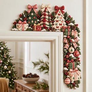 May include: A decorative Christmas door frame topper featuring three stylised trees, wrapped gift boxes, pine cones, red berries, and bows. The arrangement includes a plaid tree, a cream tree with red bows, and a green tree with ornaments.