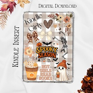 May include: A rectangular Kindle insert featuring a beige and white buffalo check pattern decorated with autumn-themed stickers including a dancing skeleton, a ghost wearing a beanie, a pumpkin spice latte, and text reading Kindle Girly and Spooky Season.