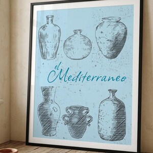 May include: A framed wall art print featuring a light blue background with a distressed texture and six black ink-style illustrations of various ceramic vases and jars. The text "el Mediterraneo" is printed in a dark blue script font in the center.