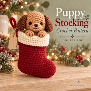 May include: A crochet puppy peeking out of a red and white Christmas stocking. The puppy is light brown with dark brown ears. A blank beige tag hangs from the stocking loop. Text reads: Puppy Stocking Crochet Pattern DIGITAL PDF.