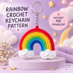 May include: A crochet rainbow keychain with a silver metal ring and chain. The rainbow features concentric bands of red, orange, yellow, green, and blue yarn, with white clouds at each end. Text reads: RAINBOW CROCHET KEYCHAIN PATTERN INSTANT PDF DOWNLOAD.