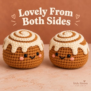 May include: Two crocheted cinnamon roll plushies with brown yarn bodies, cream-colored icing swirls, black bead eyes, and pink stitched cheeks. The text "Lovely From Both Sides" appears above, and "little bloom craft and co" is at the bottom.