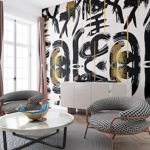 May include: A wall mural featuring bold black brushstrokes and gold speckled accents on a white background. The design includes repeating abstract circular motifs and vertical gold lines, creating a high-contrast graphic pattern across the wall.