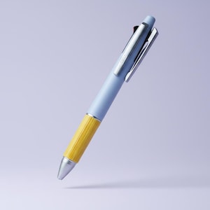 May include: A retractable ballpoint pen featuring a matte light blue barrel, a textured mustard yellow grip section, and a silver-toned metal pocket clip. The pen has a conical silver tip and a matching silver button mechanism at the top end.