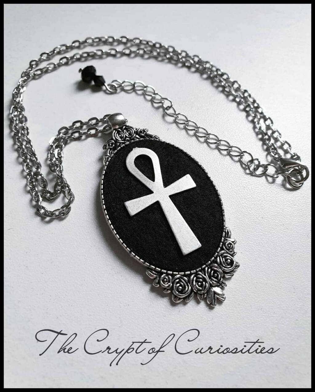 Gothic ankh and rose cameo necklace.