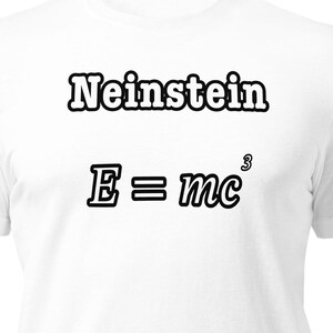 May include: A white short-sleeved t-shirt featuring the black text Neinstein and the equation E = mc³ printed on the front. A small orange and black circular logo is visible on the left sleeve, adding a distinct detail to the plain white garment.