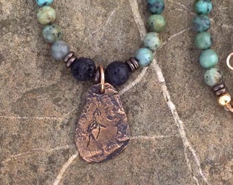 Mens or womens unisex necklace with african turquoise,black lava stone, brass beads, handmade bronze pendant. Rustic, impala cave art, boho