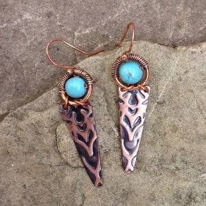 Tribal, boho style earrings with embossed copper and turquoise howlite beads. Wirewrapped, handmade by Serafin. Reclaimed copper. Rustic