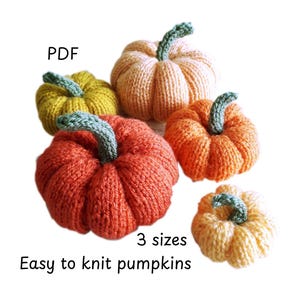 May include: A collection of five knitted pumpkins in shades of orange, yellow, and peach, each featuring a green stem. The text "PDF", "3 sizes", and "Easy to knit pumpkins" is visible. The pumpkins are textured with vertical ribbing.
