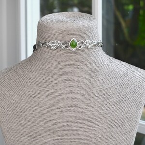 exquisite green jade stone Victorian choker necklace with a vegan leather strap. The stunning antique silver plated leaf design adds a touch of old-world charm to this boho style accessory.