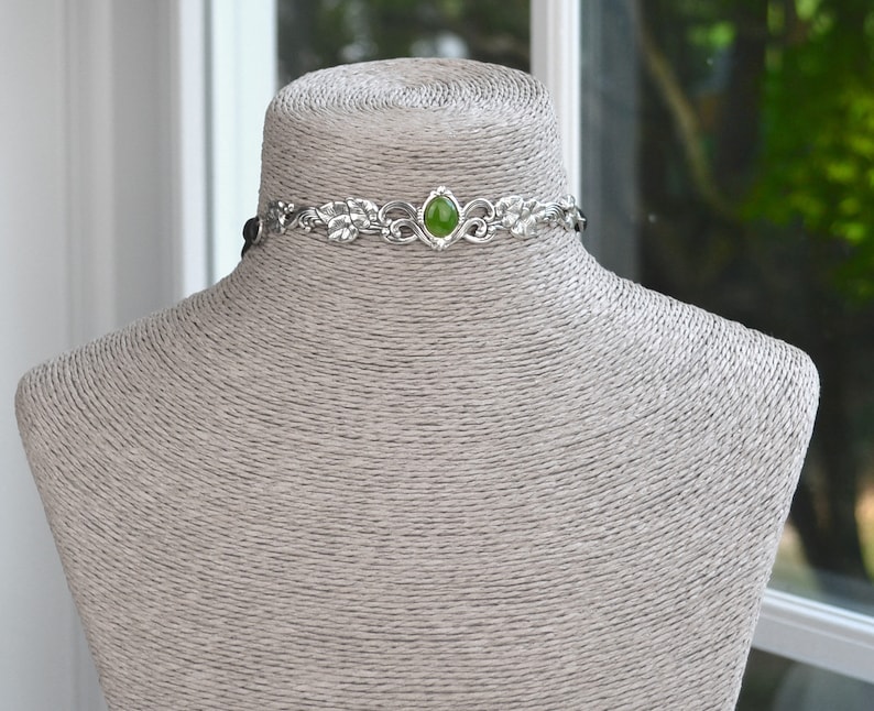 exquisite green jade stone Victorian choker necklace with a vegan leather strap. The stunning antique silver plated leaf design adds a touch of old-world charm to this boho style accessory.