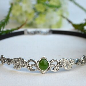 exquisite green jade stone Victorian choker necklace with a vegan leather strap. The stunning antique silver plated leaf design adds a touch of old-world charm to this boho style accessory.