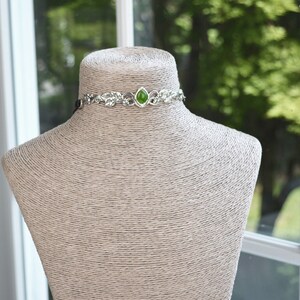 exquisite green jade stone Victorian choker necklace with a vegan leather strap. The stunning antique silver plated leaf design adds a touch of old-world charm to this boho style accessory.