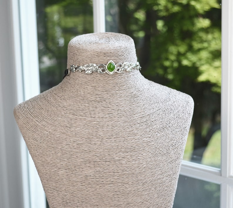 exquisite green jade stone Victorian choker necklace with a vegan leather strap. The stunning antique silver plated leaf design adds a touch of old-world charm to this boho style accessory.