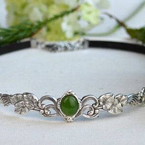 exquisite green jade stone Victorian choker necklace with a vegan leather strap. The stunning antique silver plated leaf design adds a touch of old-world charm to this boho style accessory.