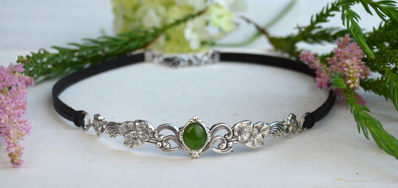 exquisite green jade stone Victorian choker necklace with a vegan leather strap. The stunning antique silver plated leaf design adds a touch of old-world charm to this boho style accessory.