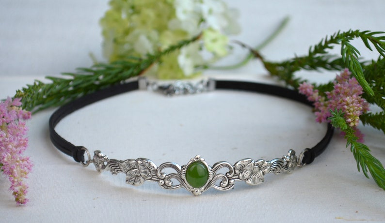 exquisite green jade stone Victorian choker necklace with a vegan leather strap. The stunning antique silver plated leaf design adds a touch of old-world charm to this boho style accessory.