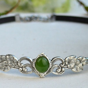 exquisite green jade stone Victorian choker necklace with a vegan leather strap. The stunning antique silver plated leaf design adds a touch of old-world charm to this boho style accessory.