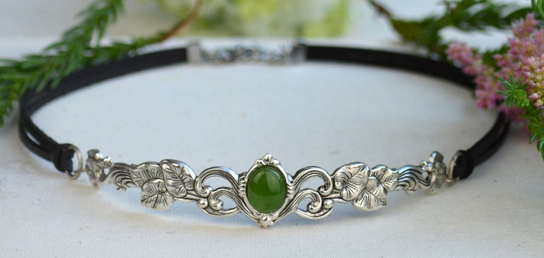 exquisite green jade stone Victorian choker necklace with a vegan leather strap. The stunning antique silver plated leaf design adds a touch of old-world charm to this boho style accessory.