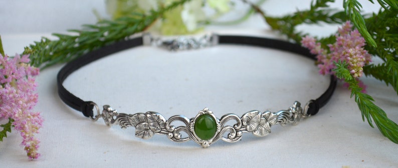 exquisite green jade stone Victorian choker necklace with a vegan leather strap. The stunning antique silver plated leaf design adds a touch of old-world charm to this boho style accessory.