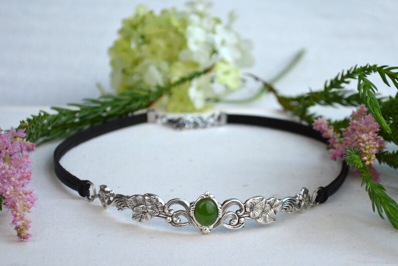 exquisite green jade stone Victorian choker necklace with a vegan leather strap. The stunning antique silver plated leaf design adds a touch of old-world charm to this boho style accessory.