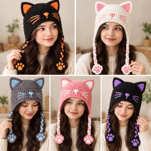 May include: A collection of five crochet cat hats featuring pointed ears, embroidered whiskers, and a nose. Each hat includes two long braided earflaps ending in crocheted paw pads. The hats are available in black with orange, white with pink, grey with blue, pink with white, and black with purple accents.
