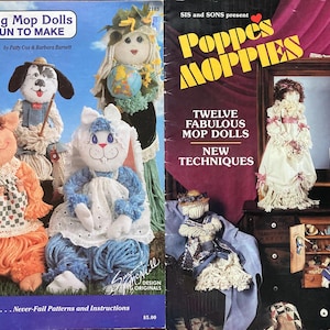 May include: Two vintage craft books featuring rag mop dolls and Poppes Moppies dolls. The "Rag Mop Dolls" book shows a pig, dog, and bunny doll. The "Poppes Moppies" book cover has a doll in a white dress.