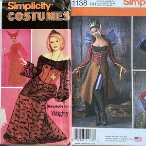 May include: Two Simplicity sewing patterns for Halloween costumes. The pattern on the left is for a witch and a vampire, and the pattern on the right is for a fairy and a goblin. The patterns are printed on pink and orange paper with black text.