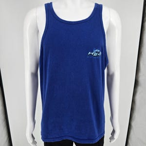 May include: A royal blue sleeveless tank top featuring a scoop neckline and a small graphic on the left chest area. The graphic displays the text H2O in a stylized white and light blue font with a water-themed design element surrounding the letters.