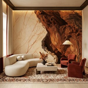 May include: A living room featuring a curved cream-colored sofa with two round pillows, a square travertine coffee table, two rust-colored velvet armchairs, and a floor lamp. The wall displays a large mural of a deep red rock formation.