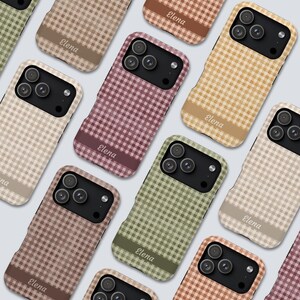 May include: A collection of smartphone cases featuring various gingham plaid patterns in muted tones of green, brown, tan, and pink. Each case includes a solid horizontal band at the bottom with the name Elena printed in white script lettering.