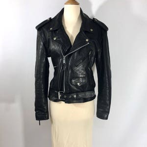 May include: Black leather motorcycle jacket with a zipper closure, a belt, and multiple pockets.