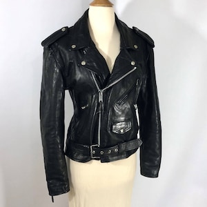 May include: Black leather motorcycle jacket with a zipper closure, a belt, and silver hardware.