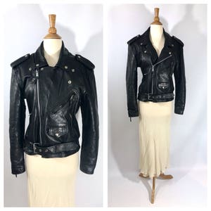 May include: Black leather motorcycle jacket with a zipper closure, a belt, and multiple pockets.