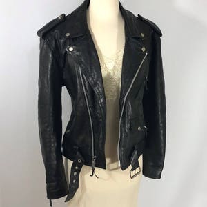 May include: A black leather motorcycle jacket with a zipper closure and a belt at the waist.