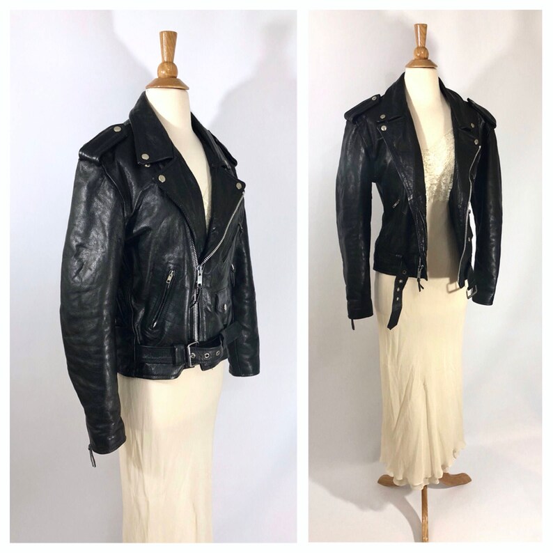 May include: Black leather motorcycle jacket with a zipper closure, a belt, and multiple pockets.