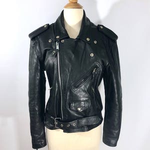 May include: Black leather motorcycle jacket with a zipper closure, a belt at the waist, and multiple pockets.